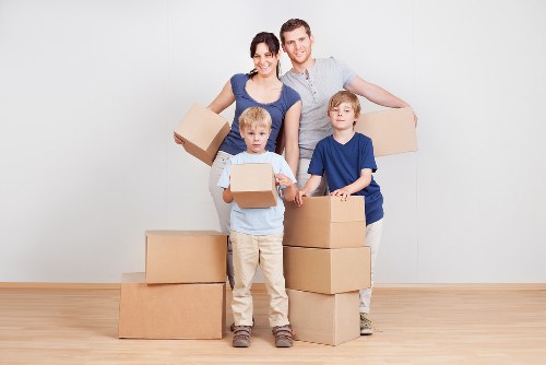 Movers handling furniture in a Hampstead flat