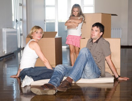Careful wrapping of fragile household items during a flat move