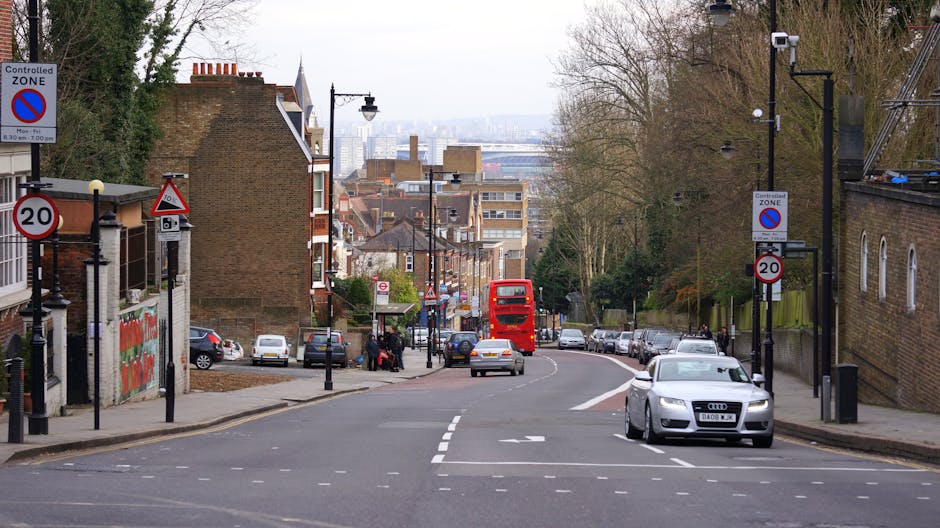 A brick building named 'The Dingwall Building' situated along the Camden Canal with a prominent sign indicating 'Hampstead Road Lock'. The structure features large arched windows on the ground floor, 